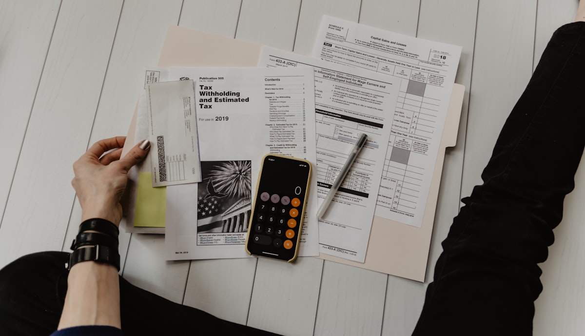 Rental property tax documents and calculator on a desk
